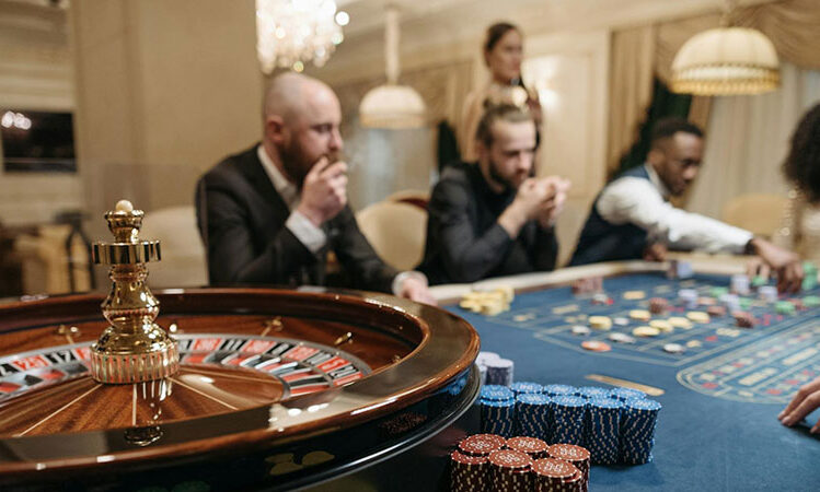 a group of people gambling and playing a roulette game at a Casino